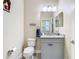 Cozy powder room features vanity with granite countertop and a decorative mirror at 5807 Circa Fishhawk Blvd, Lithia, FL 33547