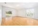 Spacious living room with wood floors, bright light, and sliding glass doors to outdoor patio at 5836 Autumn Shire Dr, Zephyrhills, FL 33541