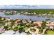 Breathtaking aerial view of a waterfront home with lush landscaping, a circular driveway, and stunning water access at 624 Balibay Rd, Apollo Beach, FL 33572