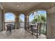 Outdoor covered balcony with seating and wrought iron railings overlooking lush greenery at 624 Balibay Rd, Apollo Beach, FL 33572