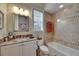 Elegant bathroom featuring granite countertops, custom tile, and natural light at 624 Balibay Rd, Apollo Beach, FL 33572