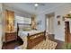 Well-lit bedroom with wood flooring, decorative rug, and large window at 624 Balibay Rd, Apollo Beach, FL 33572