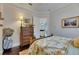 Comfortable bedroom featuring hardwood floors and a charming tropical-themed bed at 624 Balibay Rd, Apollo Beach, FL 33572
