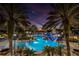 Resort-style community pool with a lighthouse, waterslides, and lush tropical landscaping at twilight at 624 Balibay Rd, Apollo Beach, FL 33572