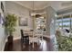 Cozy dining room with dark wood floors, modern lighting, and outdoor views through a window at 624 Balibay Rd, Apollo Beach, FL 33572