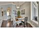 Cozy dining room with decorative chandelier, neutral walls, and dark wood floors at 624 Balibay Rd, Apollo Beach, FL 33572