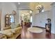 Open Foyer with dark wood floors, high ceilings, and arched entryways to dining and living areas at 624 Balibay Rd, Apollo Beach, FL 33572