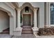 Charming entryway with ornate columns, decorative pineapples on doors, and a welcoming ambiance at 624 Balibay Rd, Apollo Beach, FL 33572