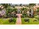 Inviting front exterior featuring lush landscaping, brick paved driveway, and a beautiful two-story home at 624 Balibay Rd, Apollo Beach, FL 33572