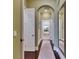 Hallway with light green walls and a view of the bathroom with a soaking tub at 624 Balibay Rd, Apollo Beach, FL 33572
