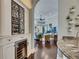 Hallway view featuring a wine fridge, wine rack, dark wood floors, and a glimpse into the living room at 624 Balibay Rd, Apollo Beach, FL 33572