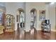 Hallway featuring arched doorways, dark wood floors, and views into the living room, bar and display cabinets at 624 Balibay Rd, Apollo Beach, FL 33572