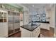 Spacious kitchen featuring black granite countertops, stainless steel refrigerator, white cabinetry, and decorative pendant lighting at 624 Balibay Rd, Apollo Beach, FL 33572