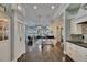 Modern kitchen featuring black granite countertops, stainless steel appliances, white cabinetry and pendant lighting fixtures at 624 Balibay Rd, Apollo Beach, FL 33572