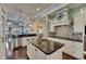 Elegant kitchen features a large island, modern appliances, and decorative hood at 624 Balibay Rd, Apollo Beach, FL 33572