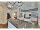 Modern kitchen featuring black granite countertops, stainless steel appliances, white cabinetry, and decorative pendant lighting at 624 Balibay Rd, Apollo Beach, FL 33572