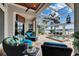 Inviting outdoor living area with comfortable seating, ceiling fan, and a gorgeous pool at 624 Balibay Rd, Apollo Beach, FL 33572