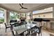 Spacious lanai with an outdoor kitchen, fireplace, and dining area overlooking the yard at 624 Balibay Rd, Apollo Beach, FL 33572