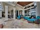 Spacious outdoor patio with luxurious seating, stone floors, and access to the home at 624 Balibay Rd, Apollo Beach, FL 33572