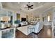 Spacious living room with dark wood floors, tray ceilings, a ceiling fan, and a walk-out to the patio at 624 Balibay Rd, Apollo Beach, FL 33572