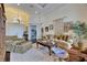 Comfortable living room with area rug, plush seating, and decorative display of pictures and greenery at 624 Balibay Rd, Apollo Beach, FL 33572