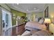 Spacious main bedroom with dark wood floors, tray ceiling, patio access, and ensuite bathroom at 624 Balibay Rd, Apollo Beach, FL 33572