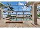 Beautiful screened lanai with inground pool, patio, and water view at 624 Balibay Rd, Apollo Beach, FL 33572