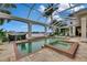 Beautifully landscaped pool and spa area with comfortable lounge seating and serene water views at 624 Balibay Rd, Apollo Beach, FL 33572