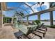 Relaxing outdoor space featuring a screened pool, spa, and waterfront views at 624 Balibay Rd, Apollo Beach, FL 33572