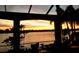 A covered seating area shows the serene waterfront views and stunning sunset colors at 624 Balibay Rd, Apollo Beach, FL 33572