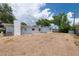 Expansive backyard view with a concrete patio, grassy area, and a well-maintained exterior at 6638 12Th N Ter, St Petersburg, FL 33710