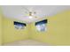 Bright bedroom with two windows, ceiling fan and neutral carpeting at 6638 12Th N Ter, St Petersburg, FL 33710