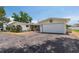 Charming single story home boasts a white garage door and a cracked dark driveway at 6638 12Th N Ter, St Petersburg, FL 33710