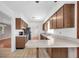 Functional kitchen equipped with oak cabinets, stainless steel appliances, and a breakfast bar at 6638 12Th N Ter, St Petersburg, FL 33710