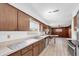 Classic kitchen showcasing wooden cabinets, tile flooring, and a breakfast bar for casual dining at 6638 12Th N Ter, St Petersburg, FL 33710