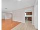 Open-concept living area showcasing hardwood floors that lead into the kitchen with tile flooring at 6638 12Th N Ter, St Petersburg, FL 33710