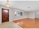 Bright living room featuring hardwood floors, chandelier, and large windows offering natural light at 6638 12Th N Ter, St Petersburg, FL 33710