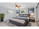 Spacious main bedroom featuring a king-sized bed, stylish decor, ceiling fan, and plenty of natural light at 6638 12Th N Ter, St Petersburg, FL 33710