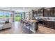 Spacious eat-in kitchen with dark cabinetry, modern stainless steel appliances, granite countertops and island with seating at 6745 Flint Creek Dr, Land O Lakes, FL 34638
