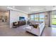 Spacious living room with modern decor, neutral sofa, geometrically paneled wall, and bright, natural light at 6745 Flint Creek Dr, Land O Lakes, FL 34638