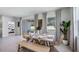Light filled dining room with a table set for guests, modern window treatments, and sliding glass door at 6761 Flint Creek Dr, Land O Lakes, FL 34638