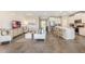 Open-concept living area with tile flooring, modern furniture, and a view of the kitchen and dining area at 6761 Flint Creek Dr, Land O Lakes, FL 34638