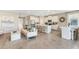 Spacious living area with modern furnishings, a kitchen island with bar stools, and a dining area at 6761 Flint Creek Dr, Land O Lakes, FL 34638