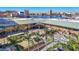 An aerial shot of a waterfront building, a marina, and the city skyline in the background on a sunny day at 700 S Harbour Island Blvd # 105, Tampa, FL 33602