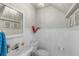 Elegant powder room with white wainscoting, a decorative mirror, and a pedestal sink under a chandelier at 700 S Harbour Island Blvd # 105, Tampa, FL 33602