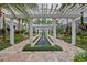 Beautiful courtyard featuring a pergola, water feature, and lush landscaping for a serene outdoor experience at 700 S Harbour Island Blvd # 105, Tampa, FL 33602