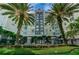Luxurious building with manicured landscaping, palm trees, and a secure gated entrance at 700 S Harbour Island Blvd # 105, Tampa, FL 33602