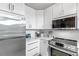 Bright kitchen featuring stainless steel appliances, stylish white cabinetry, and marble countertops at 700 S Harbour Island Blvd # 105, Tampa, FL 33602