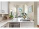 Contemporary kitchen with stainless steel appliances, white cabinets, and marble countertops, with a view to the living room at 700 S Harbour Island Blvd # 105, Tampa, FL 33602