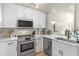 Updated kitchen with stainless steel appliances, white cabinets, and modern finishes at 700 S Harbour Island Blvd # 105, Tampa, FL 33602